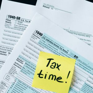 IRS 1040 tax forms with handwritten 'Tax Time!' note for filing reminder.